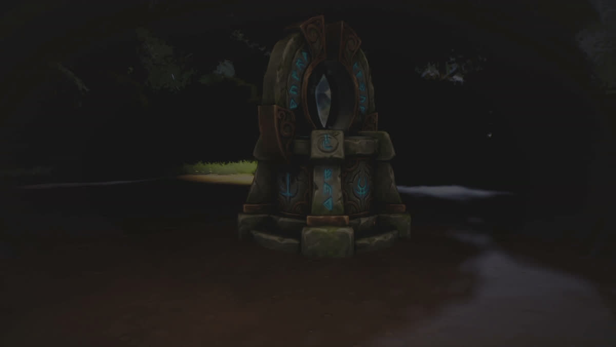 The guessing stone on a forest road at night, a carved arch with a pale crystal set in it